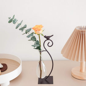 Marbrasse glass planter with flowers brightens a desk.