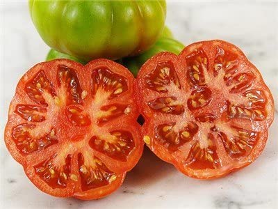 Constoluto tomato fruit on plant with large ribbed, juicy tomatoes.