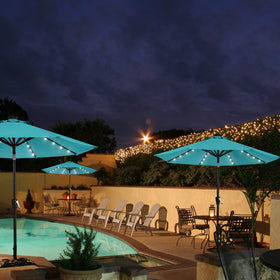 Mastercanopy turquoise umbrella on a deck for versatile outdoor comfort.