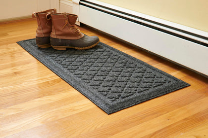 Mats Inc Artisan Entry Boot Tray with raised edge contains mud at the entryway.