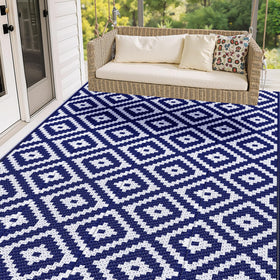 Mattitude waterproof outdoor rug laid on a blue patio for durable outdoor use