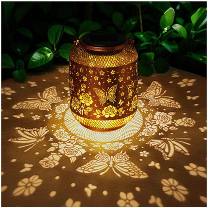 MAXTHOT butterfly solar garden statue in gold glows softly at dusk for outdoor charm.