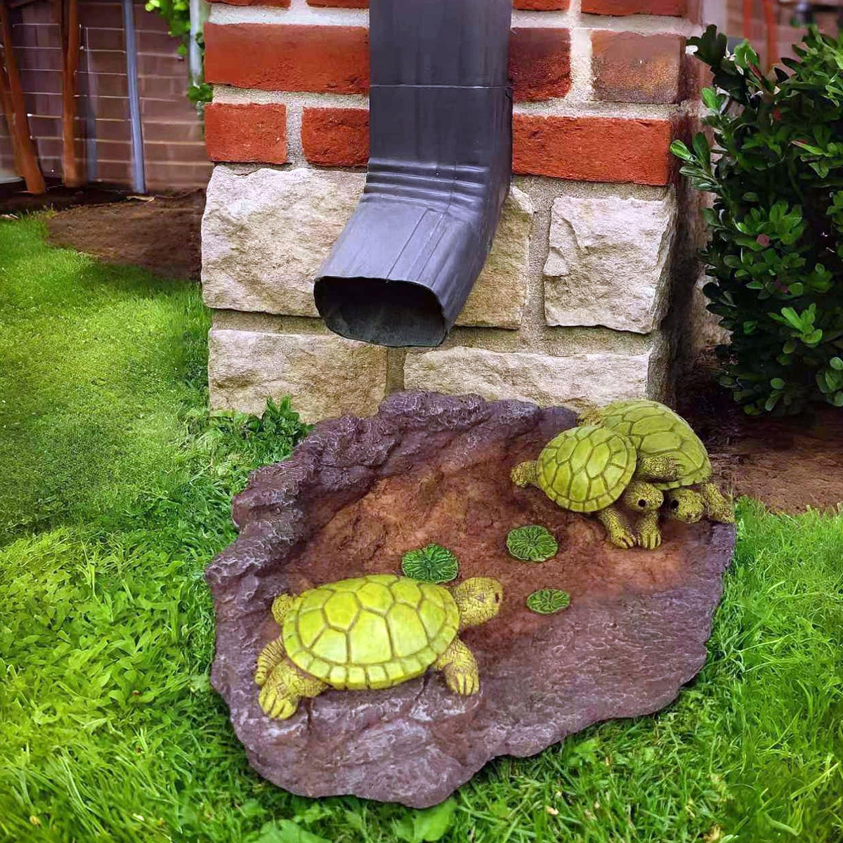 Melnixia turtle rainwater diverter helps reduce splash near entryways.