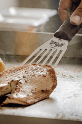 Mercer Hell's Handle fish turner featuring heat-resistant handle for high-heat cooking