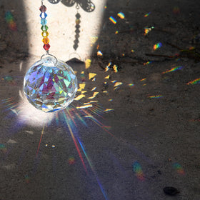 MerryNine feng-shui crystal prism 30mm enhances sunlight with balanced color reflections.