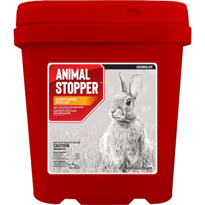 Messinas Animal Stopper Granular being poured to protect a garden bed from pests