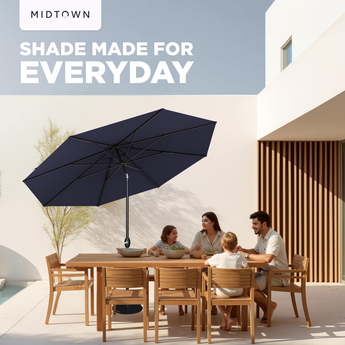 Shaded patio area with Midtown Umbrellas Lean Patio Umbrella navy coverage.