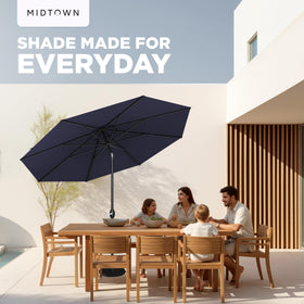 Shaded patio area with Midtown Umbrellas Lean Patio Umbrella navy coverage.