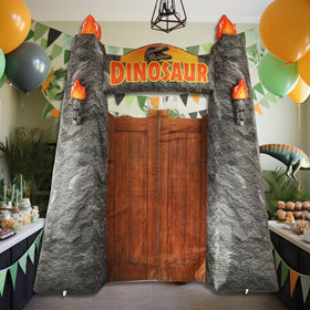 MinFyberd dinosaur arch used as a photo backdrop in yard.