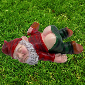 MINICAR gnome lying with wine bottle lends playful character to patios and yards.