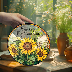 MINIVINE sunflower stained glass hangs from a chain in a sunlit room.
