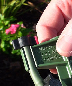 Mister Landscaper 27-inch green vinyl tubing section guiding drip lines across plant beds.
