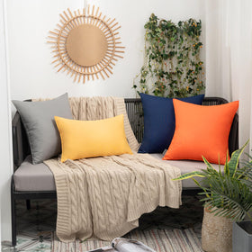 MIULEE orange pillow cover on a sofa setting for outdoor living