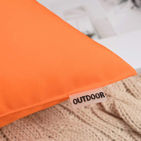 MIULEE orange waterproof pillow cover in a garden setting, keeps cushions clean