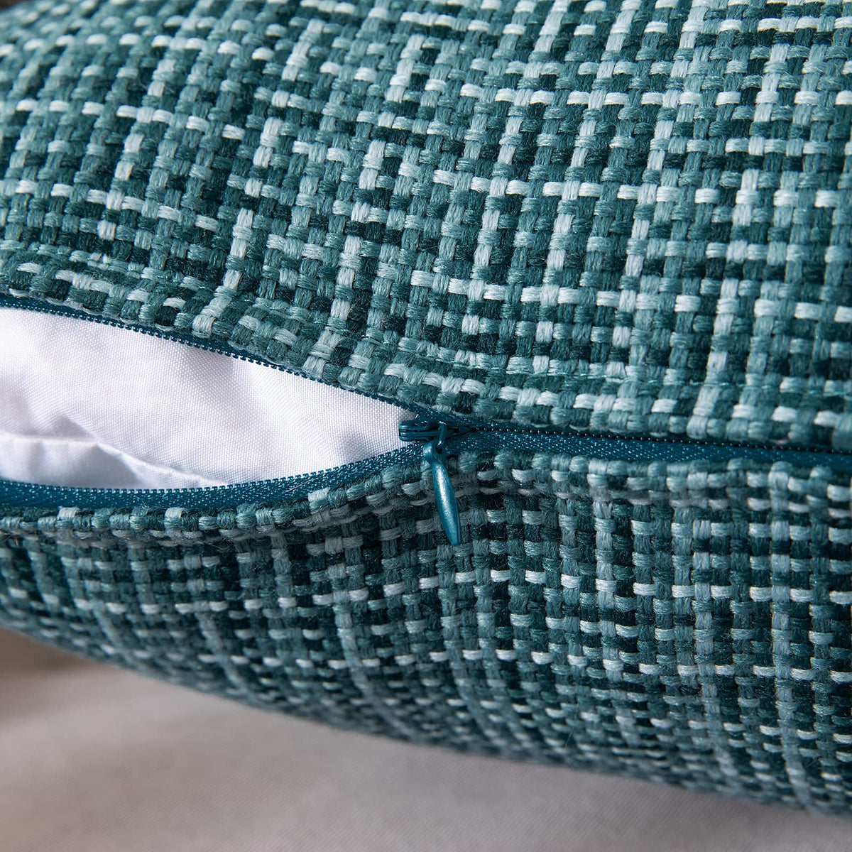 MIULEE teal pillow cover on sofa adds a pop of color to living room decor.