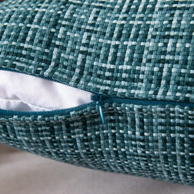 MIULEE teal pillow cover on sofa adds a pop of color to living room decor.