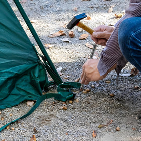 MIVIDE ground anchors supporting garden plants like trees and shrubs.