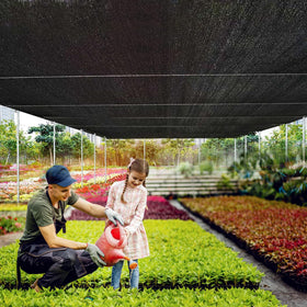 MKMJ ultraviolet-protective shade cloth diffusing sun in a garden setup.