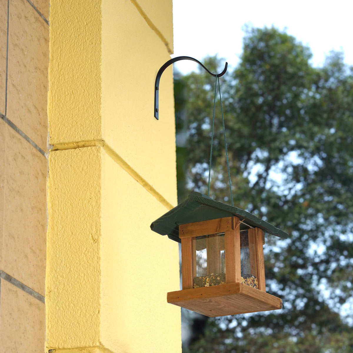 Mkono lantern hanger on wall demonstrates sturdy outdoor organization.