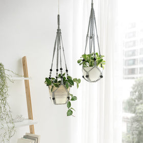 Close-up of Mkono macrame grey hanger with wood beads, showcasing craftsmanship for stylish planters.
