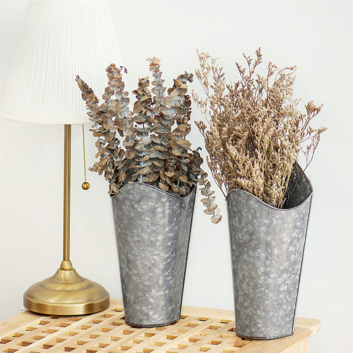 Mkono silver metal wall planters shown with decorative arrangements