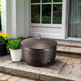 Monarch Abode ridge embossed hose holder blends durable metal with decorative curb appeal outdoors.