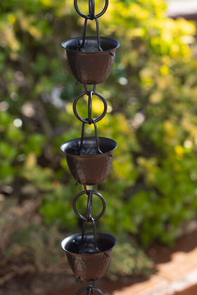 Close-up of hammered cups on Monarch Rain Chains showing craftsmanship and water flow.