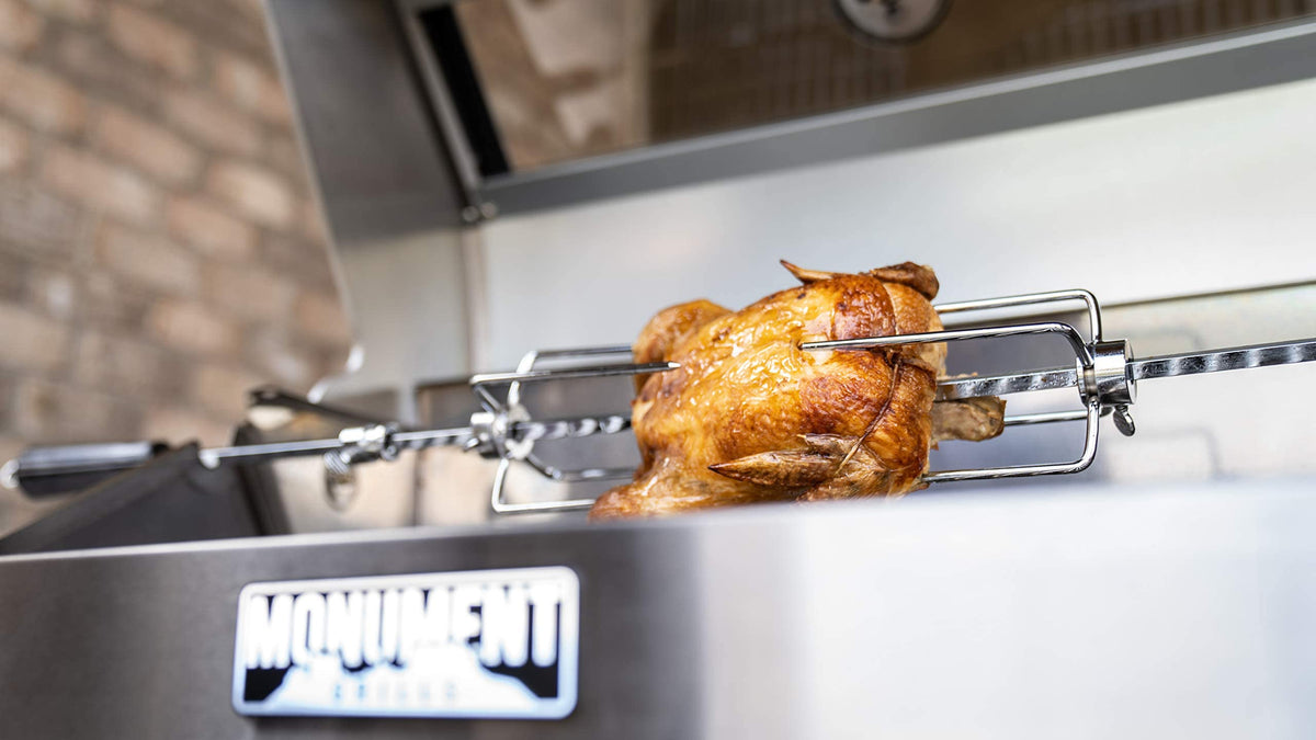 Backyard barbecue setup featuring Monument Grills rotisserie kit