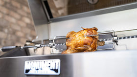 Backyard barbecue setup featuring Monument Grills rotisserie kit