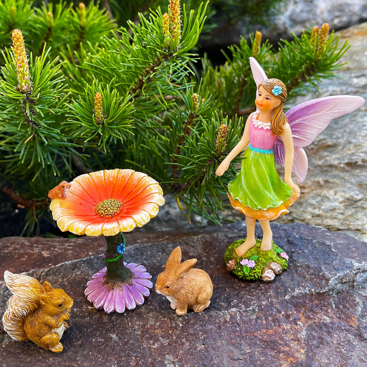 Mood Lab Fairy Garden Figurines arranged in an outdoor display