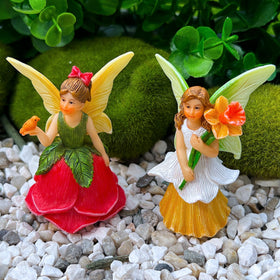 Mood Lab Rose figurine perched in a planter adds charm outdoors.