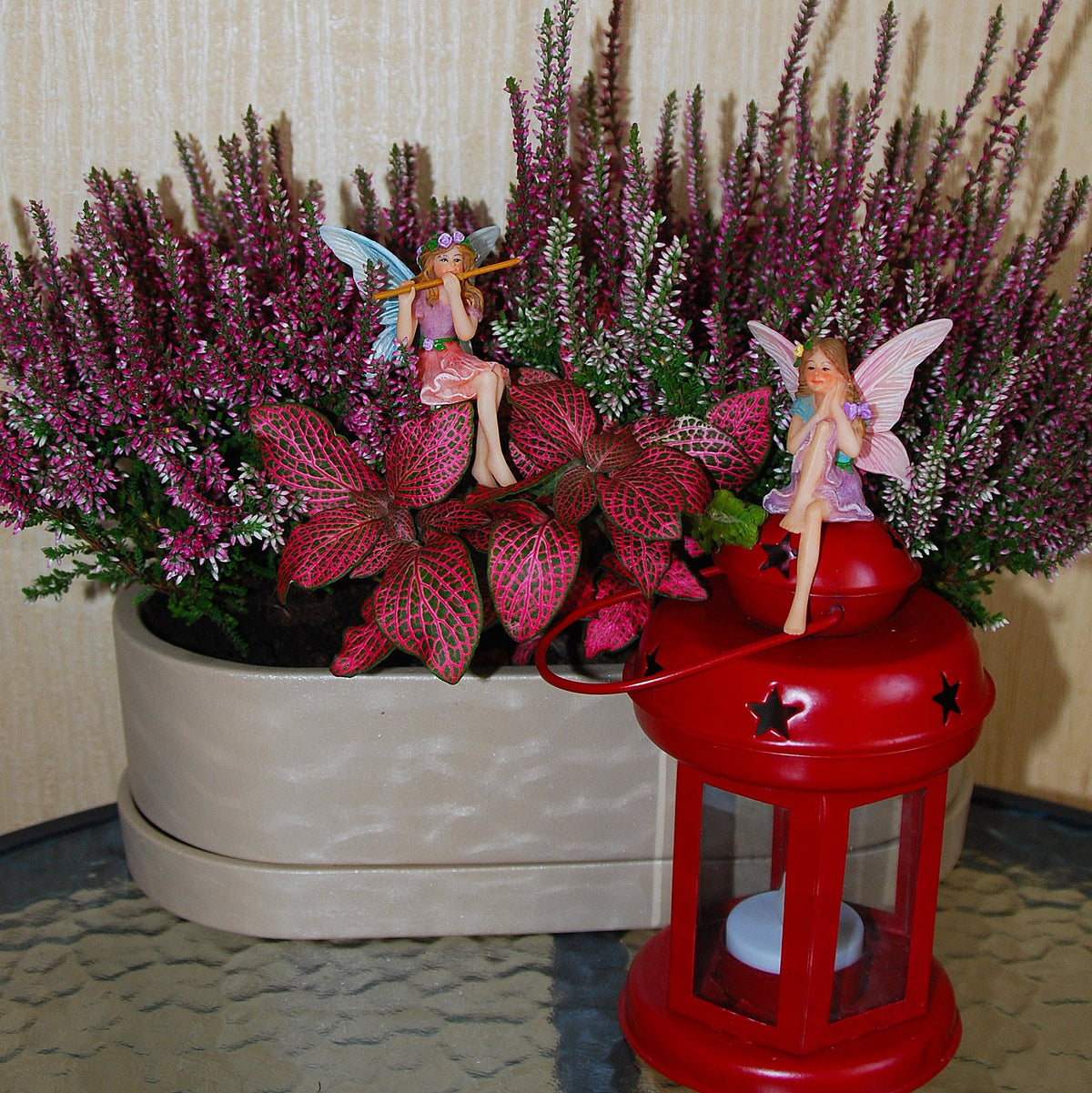 Mood Lab garden figurines guard small planters with friendly, inviting presence.