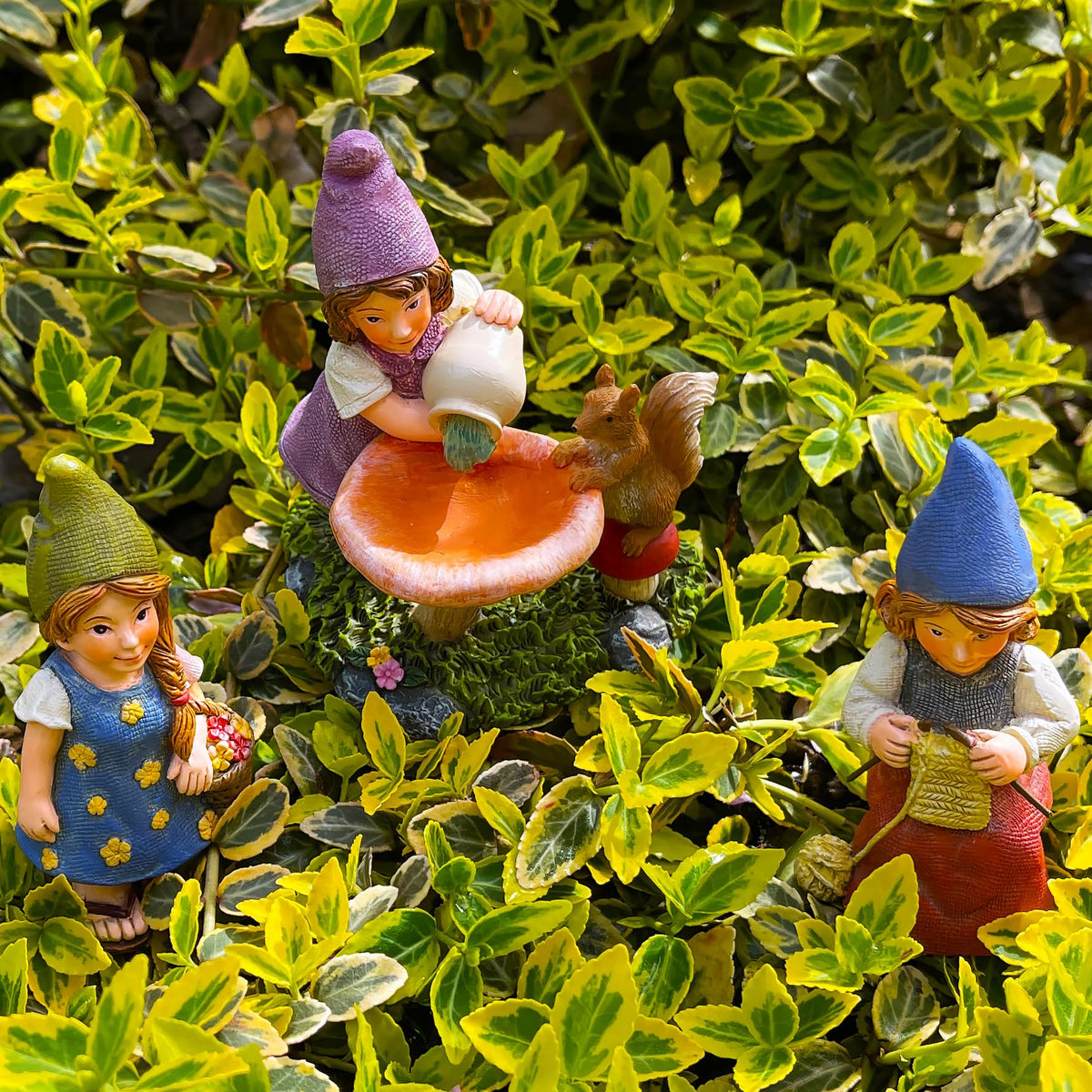 Mood Lab garden gnome lady-8 statue creates a whimsical garden vignette.