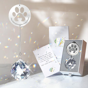 Mooncraftlogy crystal ball prism casts rainbow light for pet remembrance.