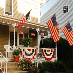 Morigins outdoor porch setup using bunting for seasonal decorations.