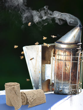 Moukeren beekeeping setup using smoker fuel to ease hive inspections.