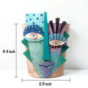 Mrlikale abstract face planter holding succulent on a desk setup.