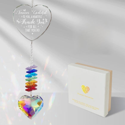 MTL HOE crystal suncatcher with rainbow heart in a sunny window