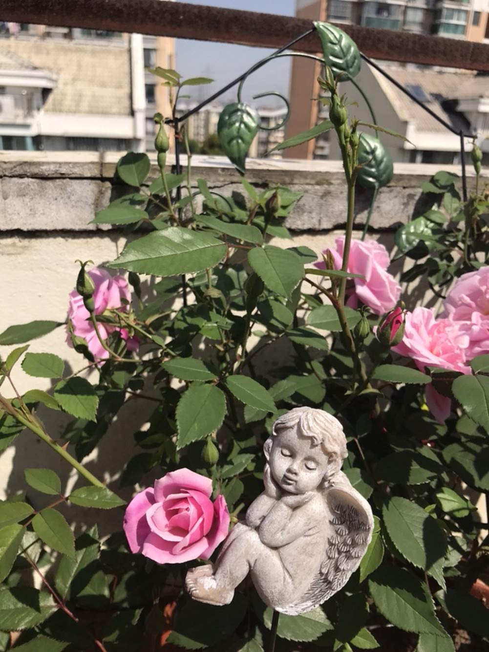 MUAMAX durable outdoor angel statue blends with floral beds and planters.