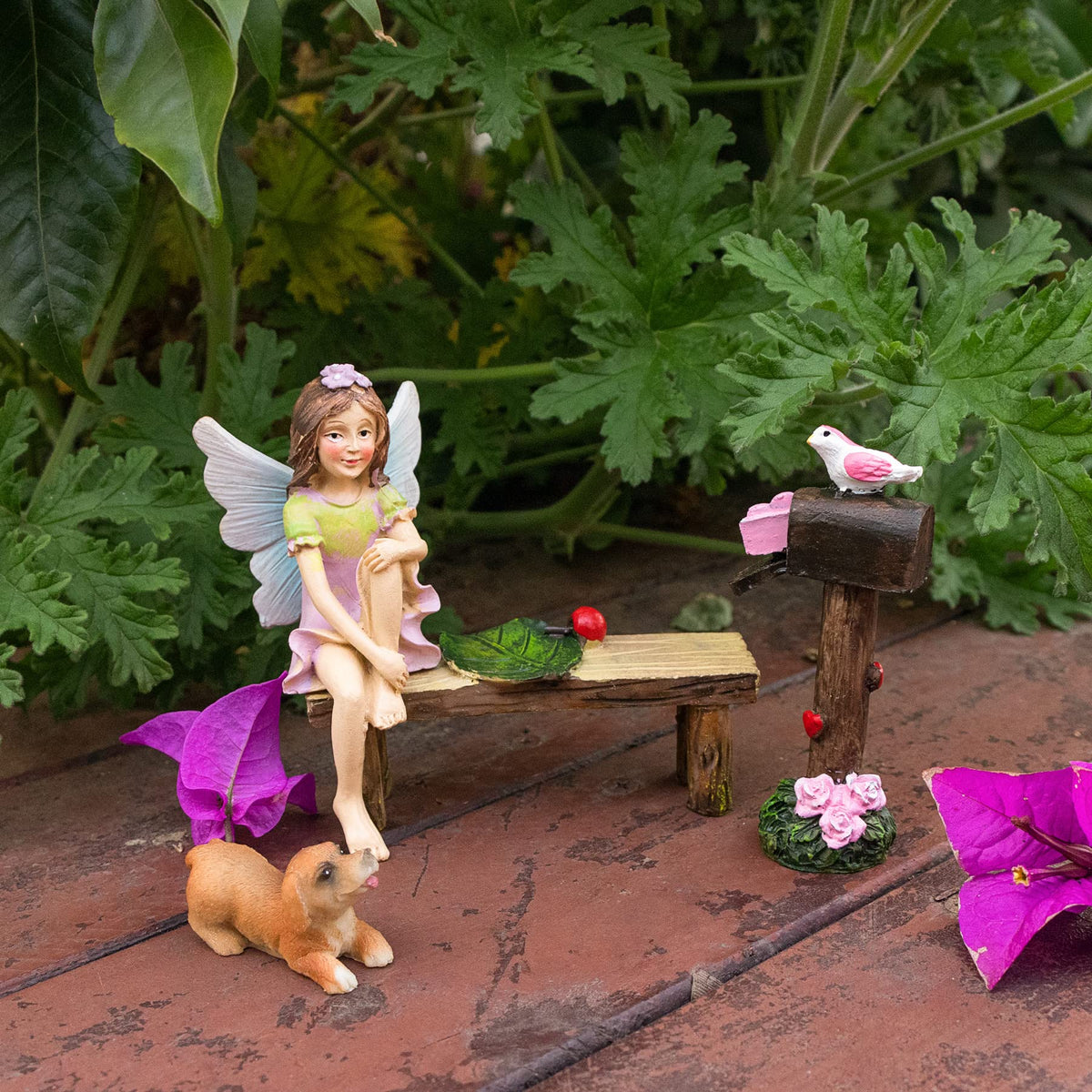 MUAMAX sitting fairies enhance planter aesthetics and storytelling.