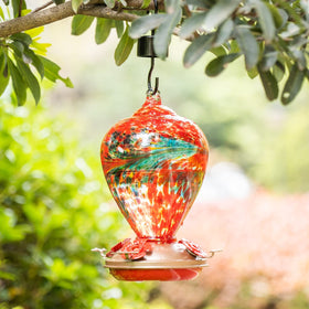 Muse Garden blown glass hummingbird feeder showcases handcrafted detail for garden art.