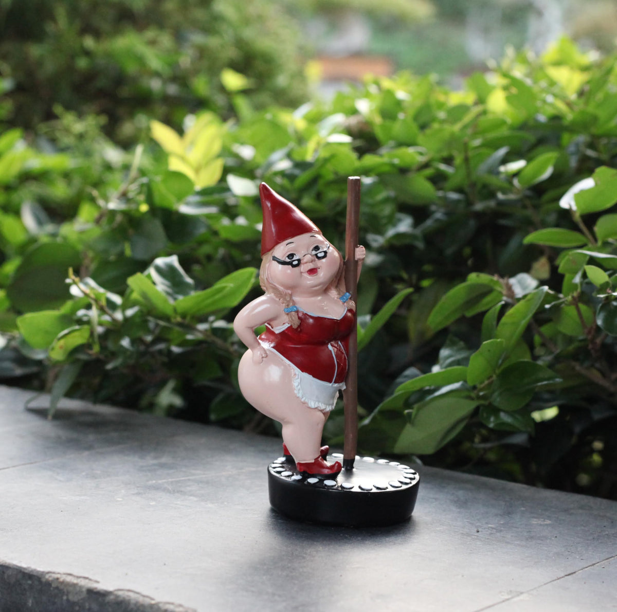 MYSTIC MANUSCRIPT steel pipe dancers dwarf statue on balcony creates playful ambiance