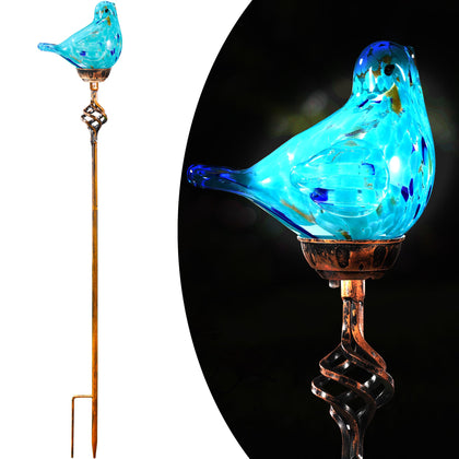 Naboher bird stake light in light blue glass brightens outdoor pathways at dusk