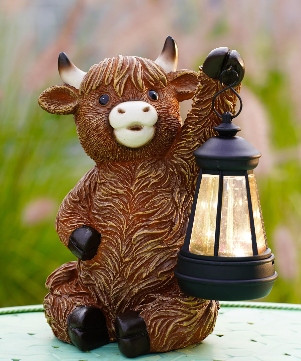 Nacome Highland Cow statue in the garden adds charming outdoor decor.