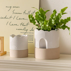Nihow round ceramic planter featuring wick for easy moisture management.