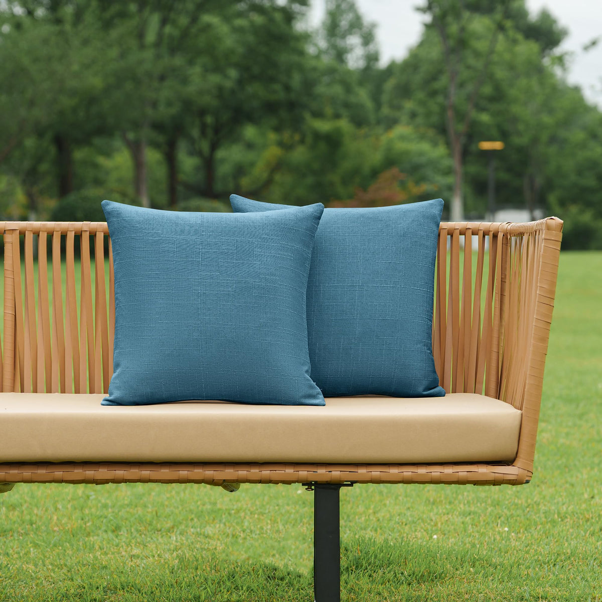 NiNi ALL dark blue outdoor pillow cover on a garden bench for cohesive styling