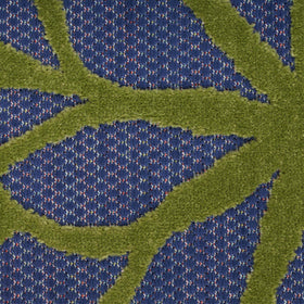 Nourison Aloha rug demonstrates easy cleaning by rinsing with a hose.