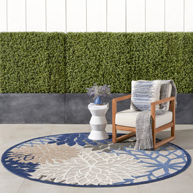 Nourison Aloha round rug in blue multicolor floral design for outdoor spaces.