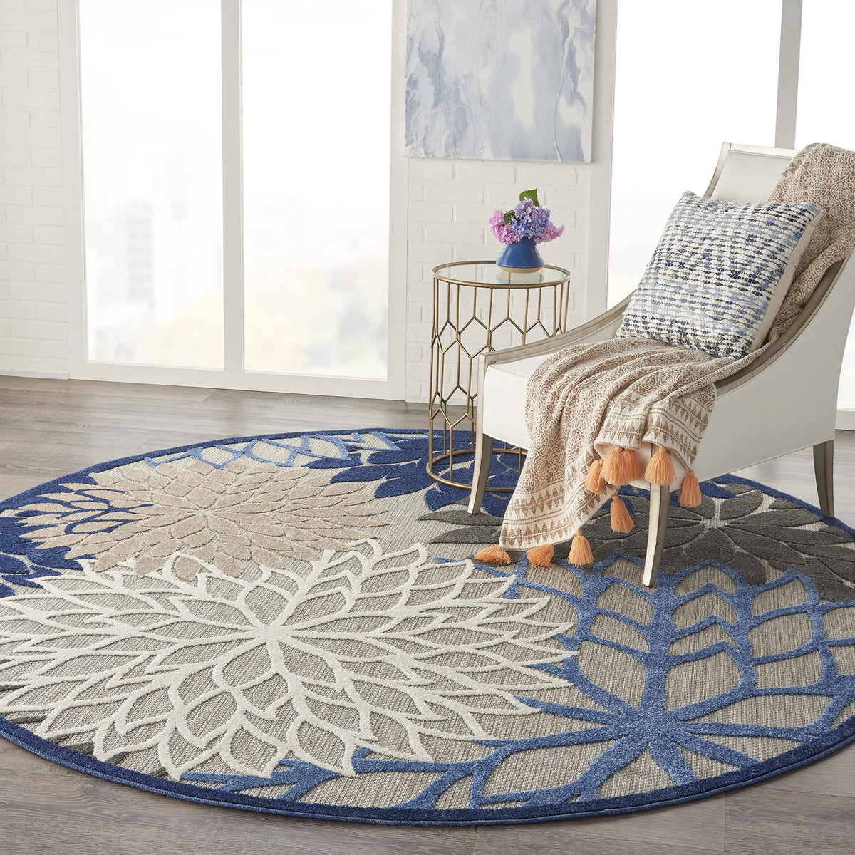 Nourison Aloha round rug with high low pile enhances tactile feel.