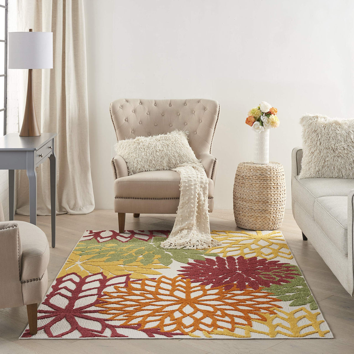 Nourison Aloha rug with bright tropical colors creates a vibrant deck focal point.